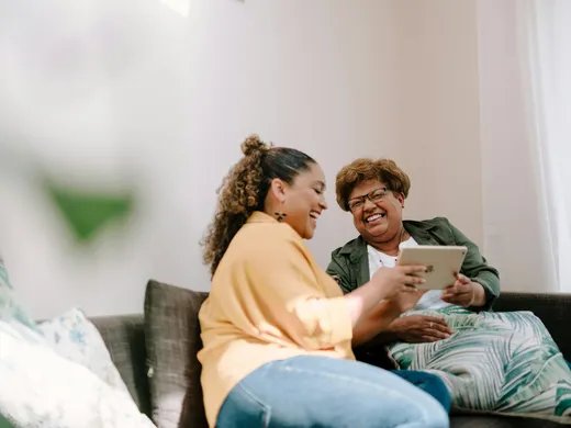 An adult daughter and her mother at home
